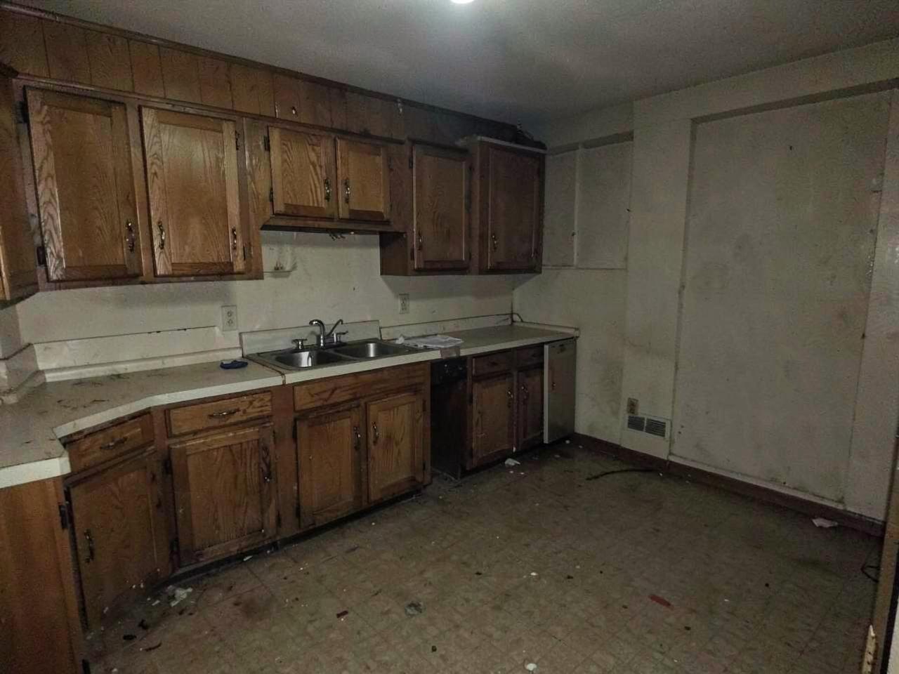 Dated kitchen with worn oak cabinets before renovation